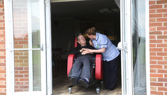 A resident takes in some fresh air and the view at Elmhurst Care Home.